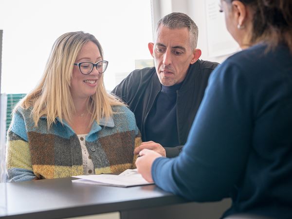 Smiling couple looking at brochure