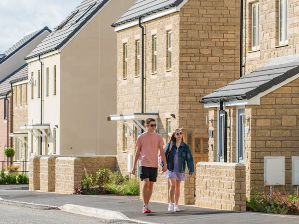 Young couple walking through new build development