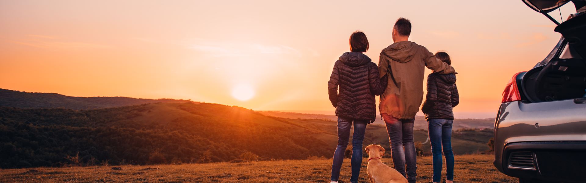 Family On A Hill Watching Sunset