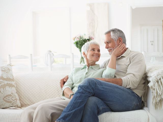 Older Couple Cuddling on Couch