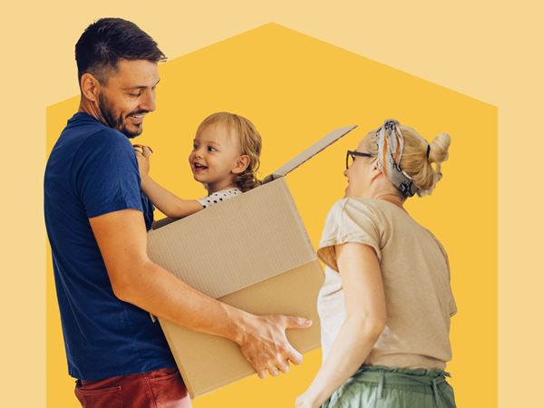Smiling parents holding babby in box against yellow background