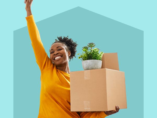 Happy woman holding a cardboard box on blue background