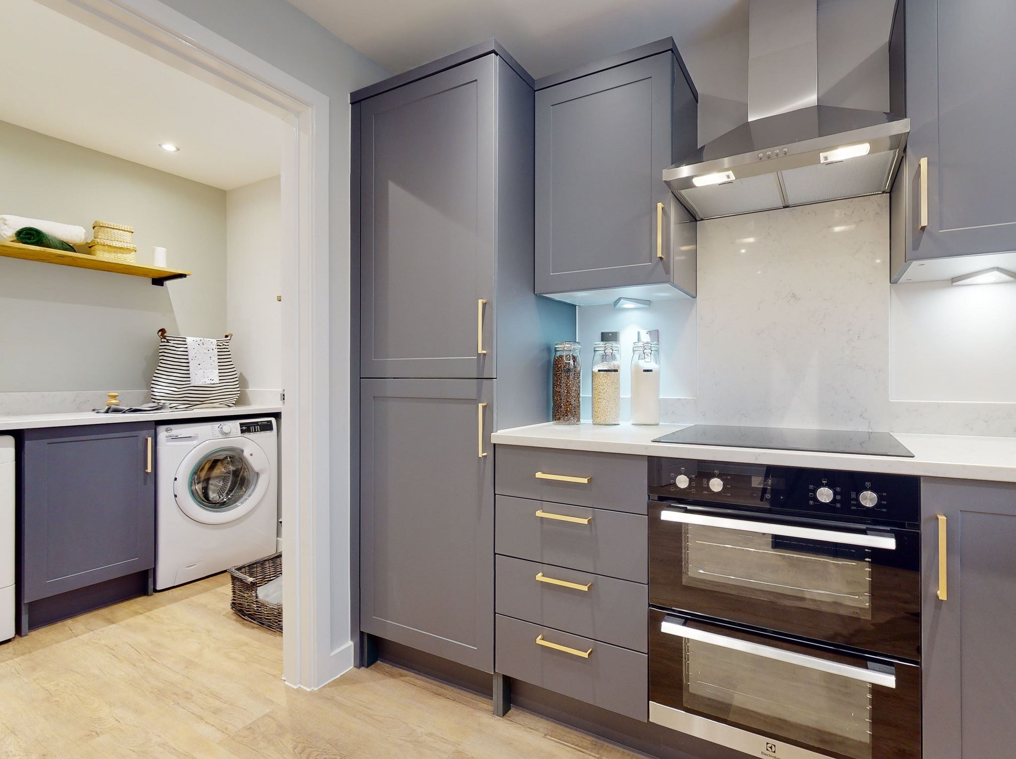 Persimmon kitchen and utility room with grey fitted cabinets and gold handles