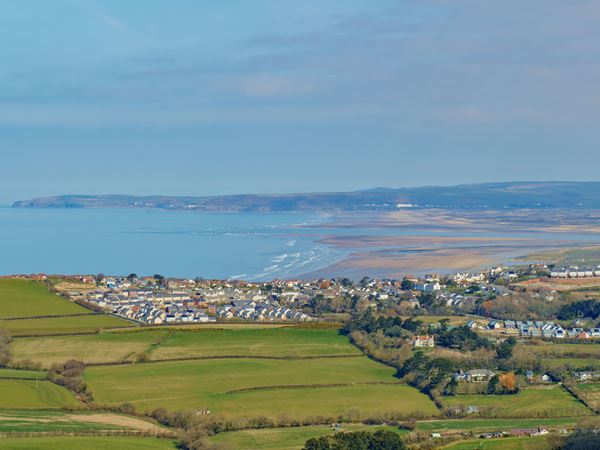 View of Bideford Beach with fields, the coast and new homes 